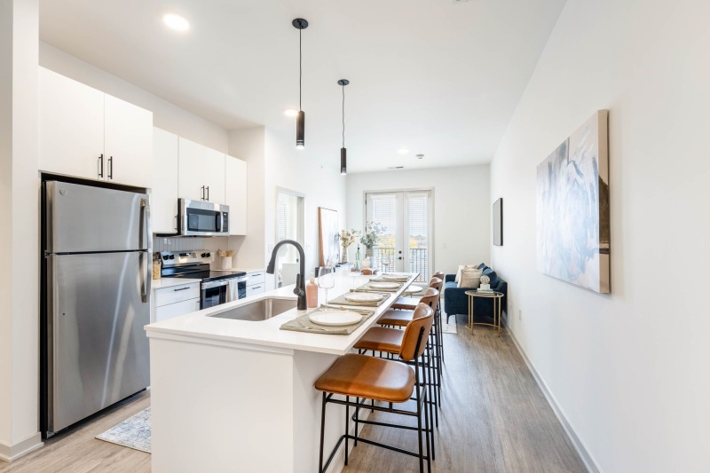 a kitchen with a dining table and a refrigerator