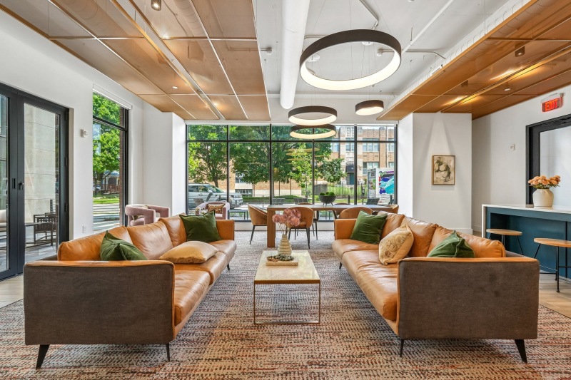 a lounge with seating and large windows