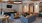 a living room with a bar and chairs