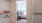 closet leading to a bedroom with a bed and a window